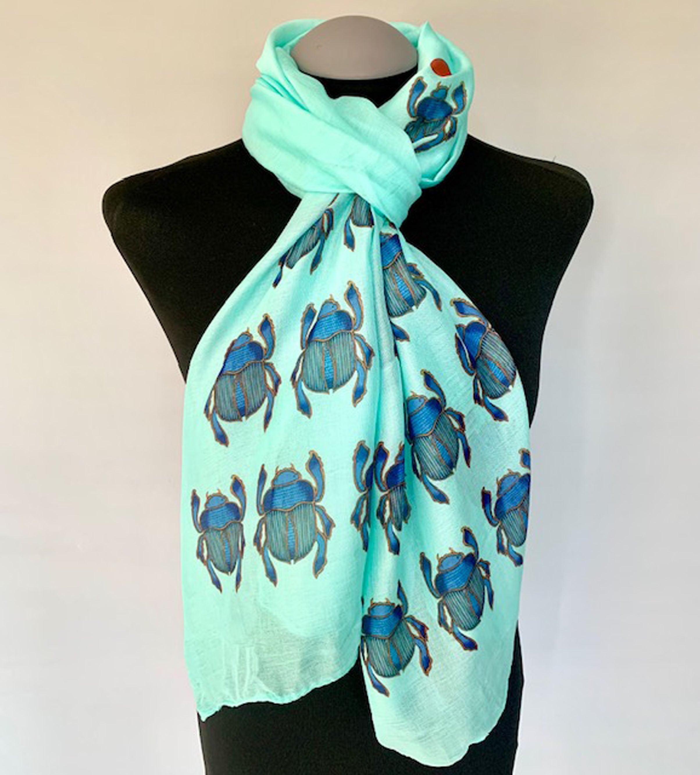 Wearable aqua art scarf with blue scarab beetle print