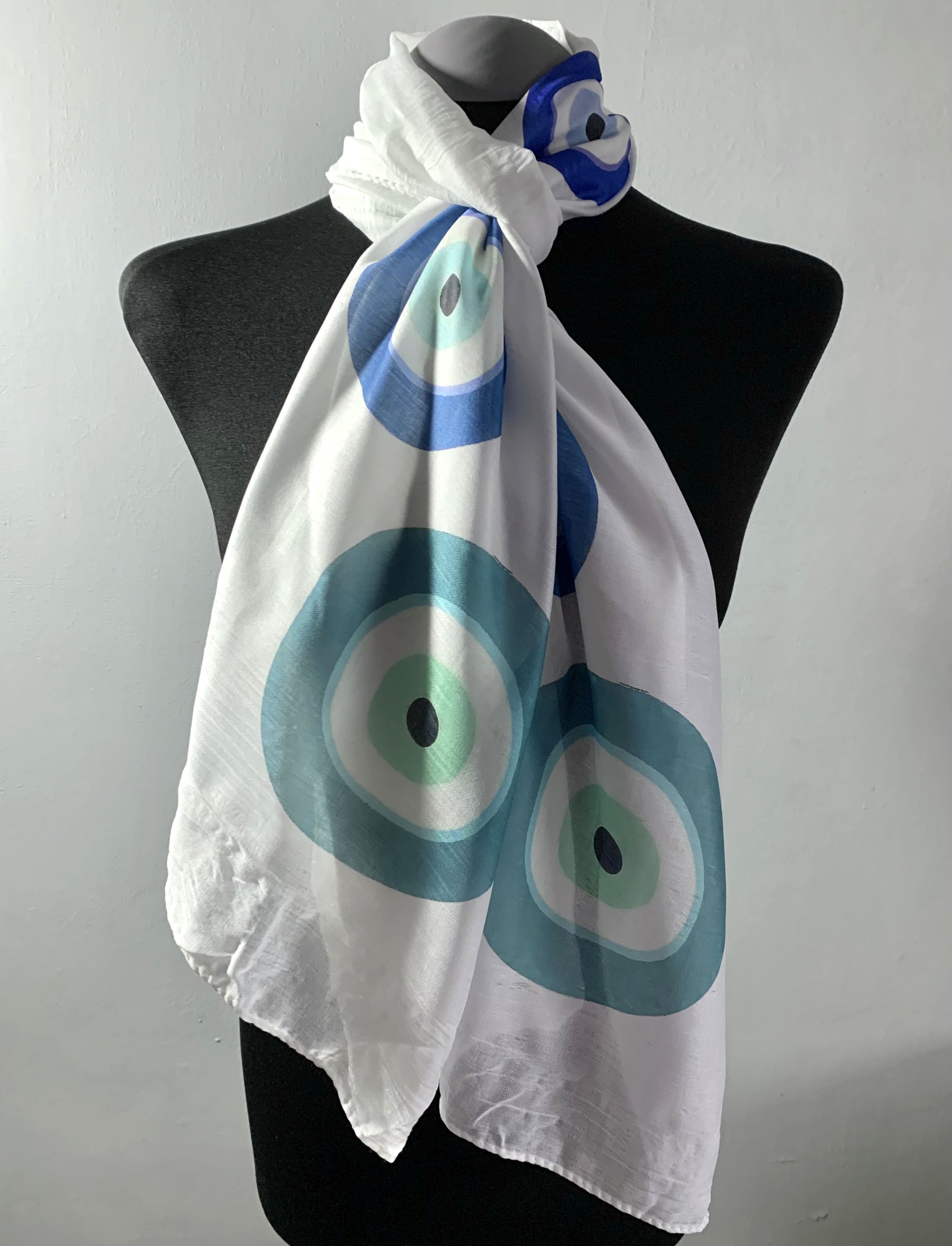 Wearable art scarf featuring blue evil eye print
