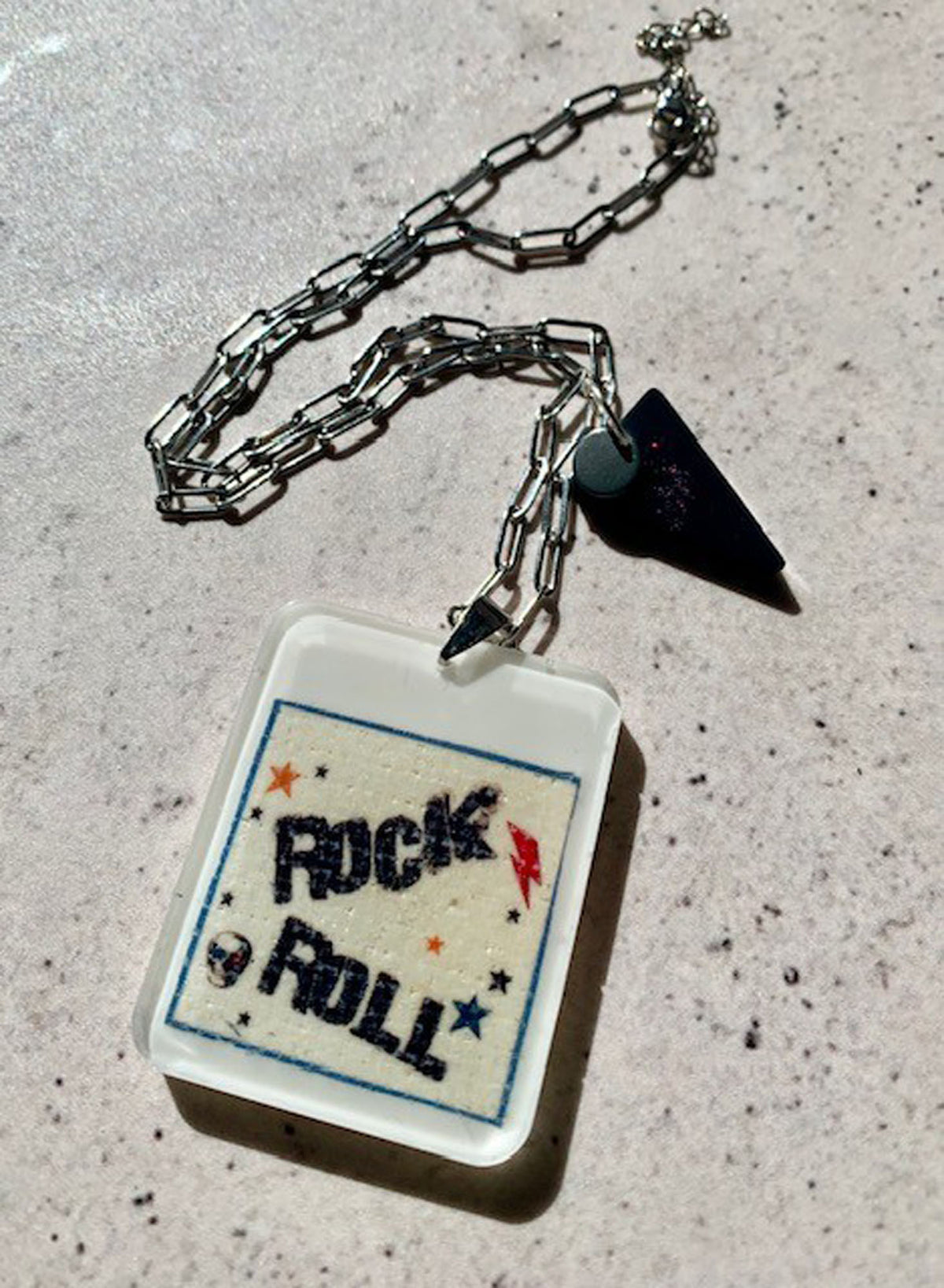 necklace with handcrafted ivory resin pendant with rock n roll graphic print embedded