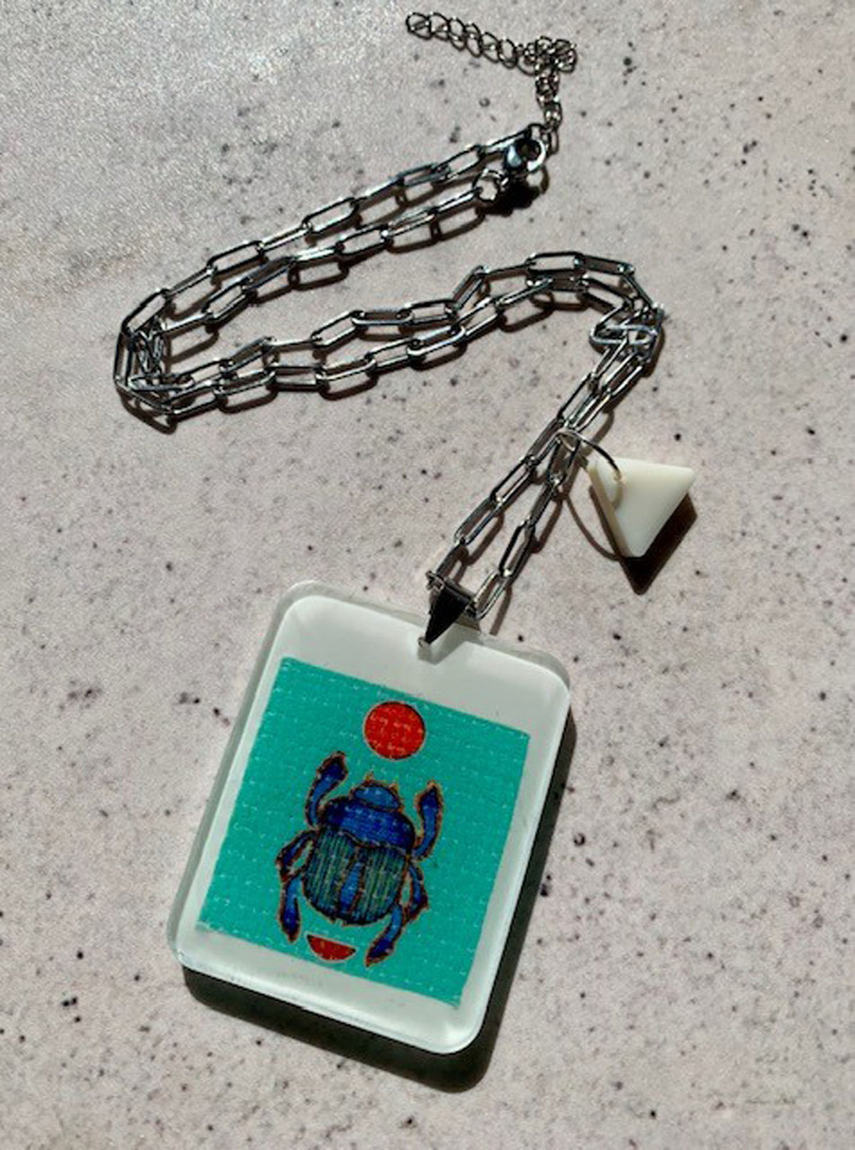 necklace with hand crafted ivory resin pendant with scarab beetle artwork embedded
