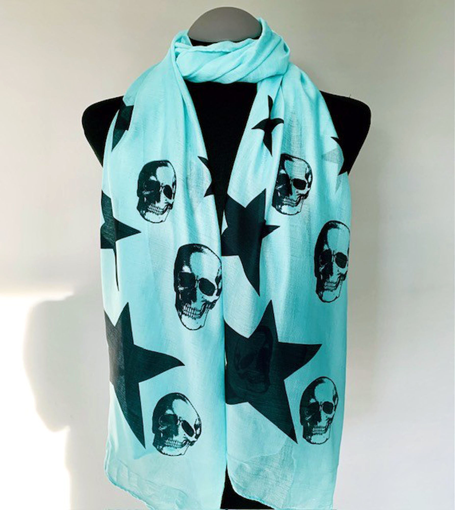 Wearable aqua turquoise art scarf with black skulls and stars print